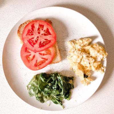 Scrambled eggs, steamed spinach, and sourdough toast