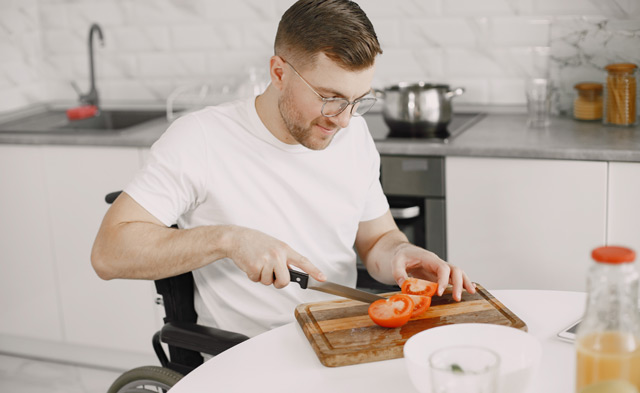 Man in wheelchair preparing food