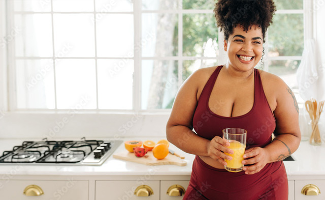 plus-sized-woman-smiling-with-orange-juice.jpg