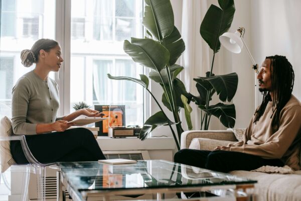 Two people sitting down and talking