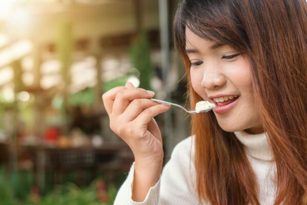 woman eating yogurt