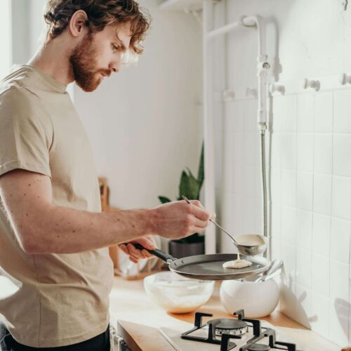 man cooking pancakes