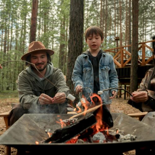 Family roasting marshmallows on a fire