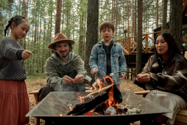 Family roasting marshmallows on a fire