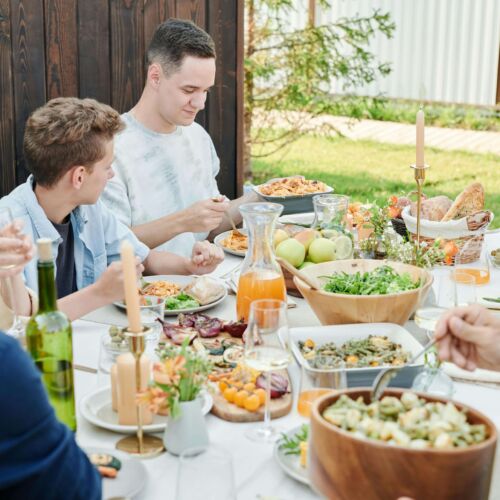 Teenager and family eating a meal.